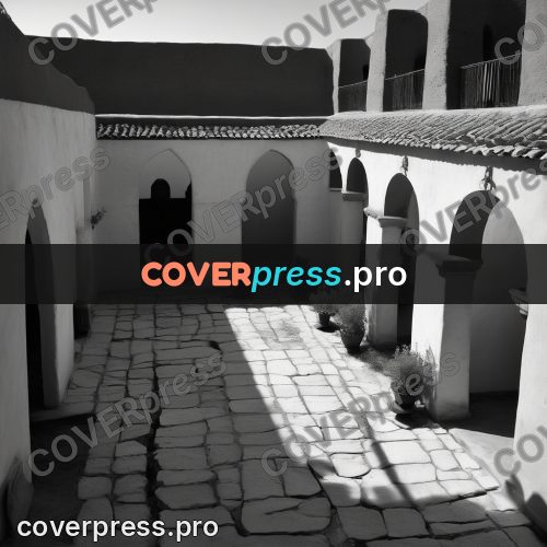 Black and white photo: courtyard with an arcade in shadow