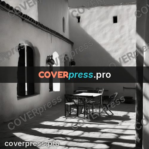 Black and white photo: courtyard with an arcade in shadow