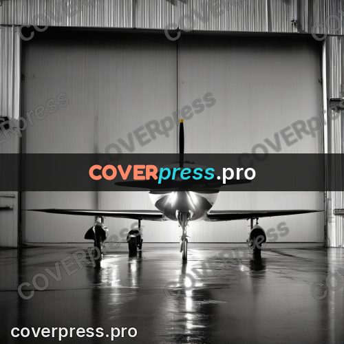Black and white photo: aeroplane in a hangar